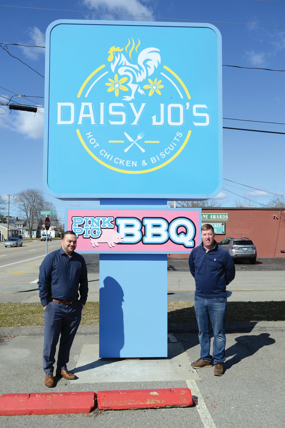 SIGN OF THINGS TO COME: The Pink Pig BBQ sign will soon be gone, but the Daisy Jo’s sign will hopefully bring in lots of hungry, curious diners to the new Daisy Jo’s, opening this month within a couple weeks, according to co-owners Ed Brady and Jeff Quinlan.